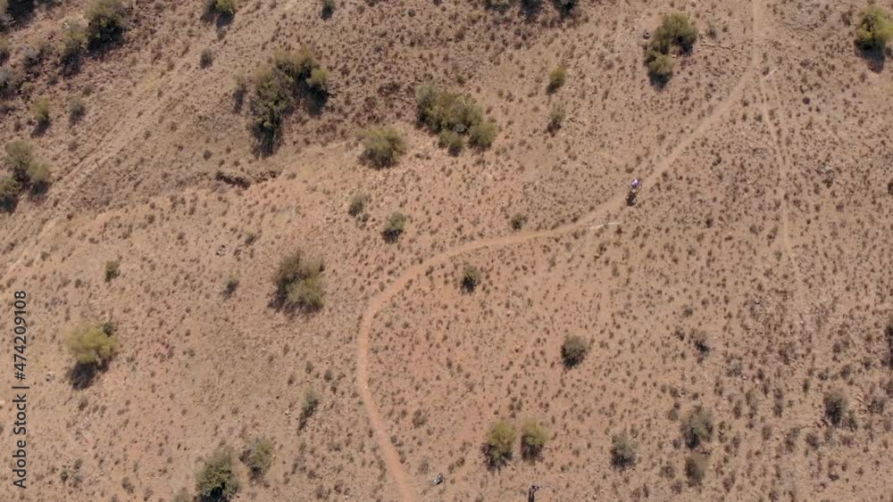Birds eye aerial view of a mountain biker climbing a single track Birds eye aerial view of a mountain biker climbing a single track
