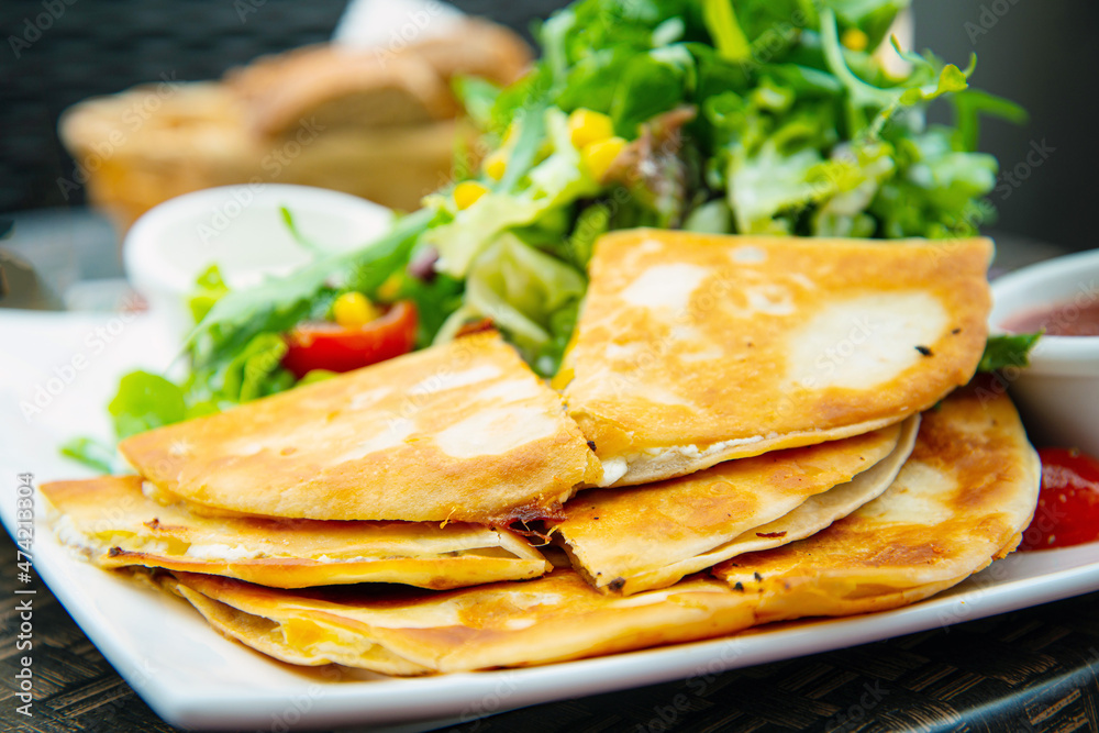 Delicious Mexican beef quesadillas with fresh lettuce and guacamole sauce Delicious Mexican beef quesadillas with fresh lettuce and guacamole sauce
