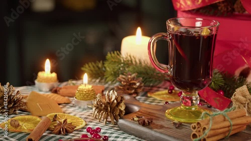 Wallpaper Mural Hot wine in glass mug, gluhwein and cinnamon close-up. Mulled red wine with star anise, decorative pinecones, burning candles. Traditional winter drinks. Christmas holidays and new year time concept. Torontodigital.ca