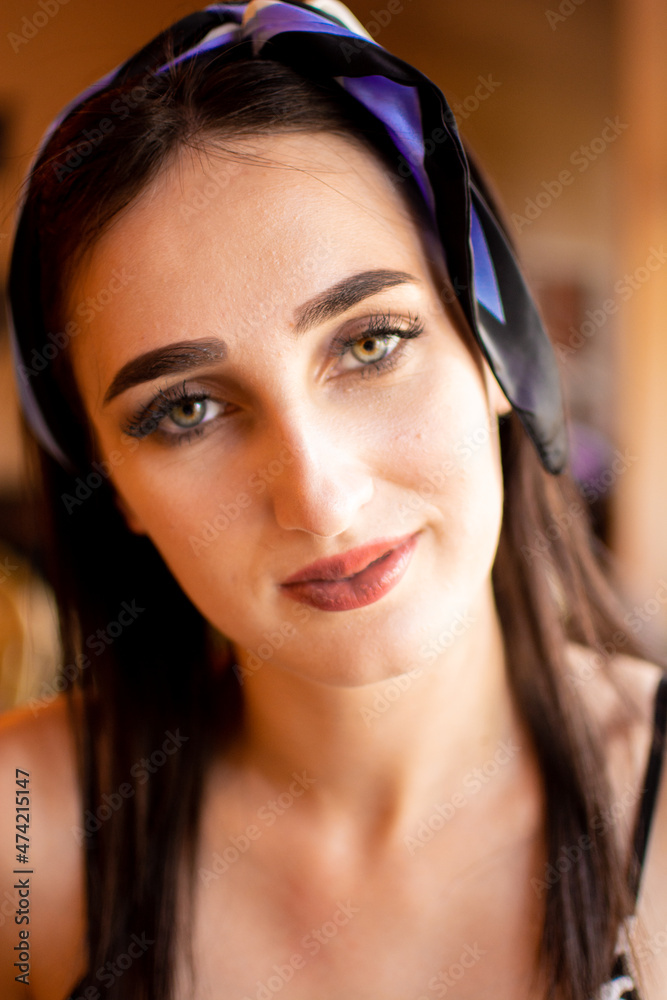 portrait of young woman drinking coffee at table with notebook in cafe