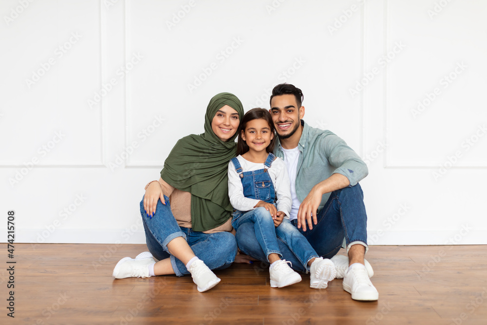 Happy man, woman and girl looking at camera Happy man, woman and girl looking at camera