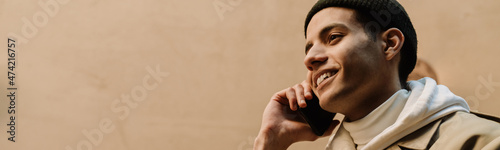 Middle eastern man smiling while talking on cellphone