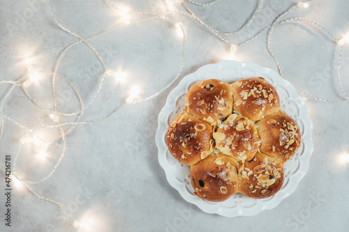 Homemade traditional sweet bread - called in German Dreikönigskuchen or Three Kings Bread - baked in Switzerland on January 6. Person who finds the king inside the bread, gets the crown. photo