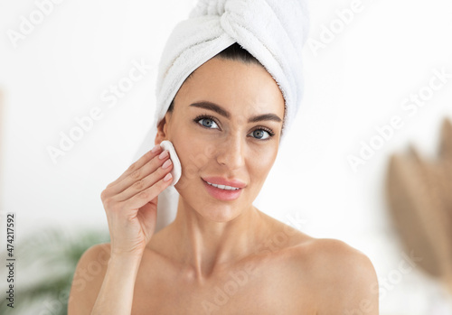 Make up remover. Woman with sponge and micellar water. Skin care and beauty