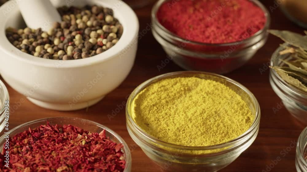 Various spices in glass bowls close-up. Middle eastern and arabian culture. Seasoning and flavors. Pepper, coriander, cinnamon, turmeric, paprika, cumin. Different kinds of dry herbs for cooking. Various spices in glass bowls close-up. Middle eastern and arabian culture. Seasoning and flavors. Pepper, coriander, cinnamon, turmeric, paprika, cumin. Different kinds of dry herbs for cooking.