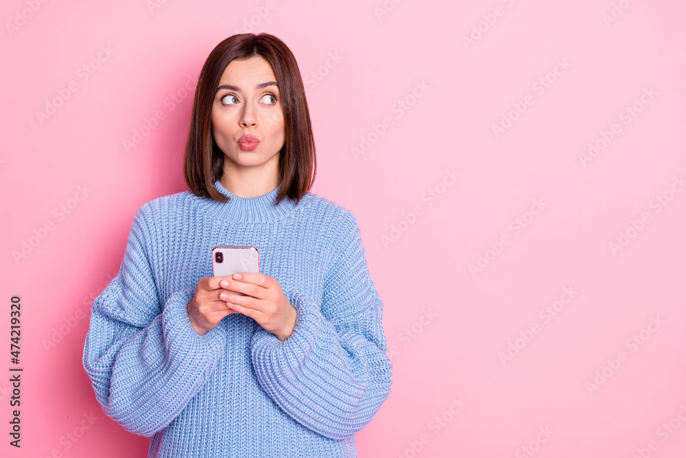 Portrait of attractive minded funky girl influencer using gadget thinking post copy space pout lips isolated over pink pastel color background Portrait of attractive minded funky girl influencer using gadget thinking post copy space pout lips isolated over pink pastel color background