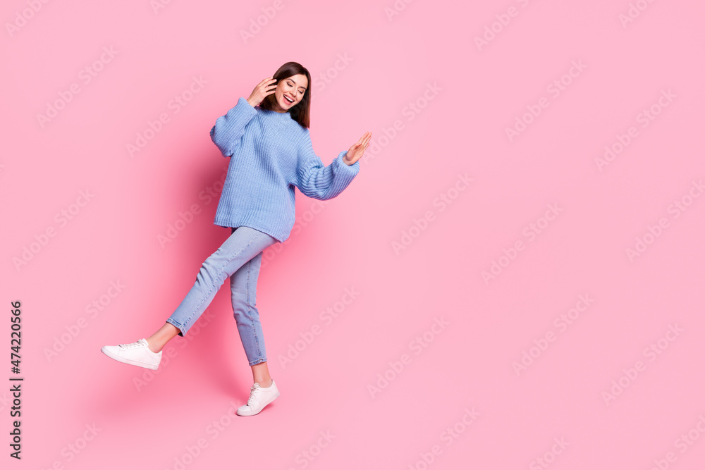 Full length body size view of attractive cheerful brown-haired girl dancing copy space isolated over pink pastel color background Full length body size view of attractive cheerful brown-haired girl dancing copy space isolated over pink pastel color background