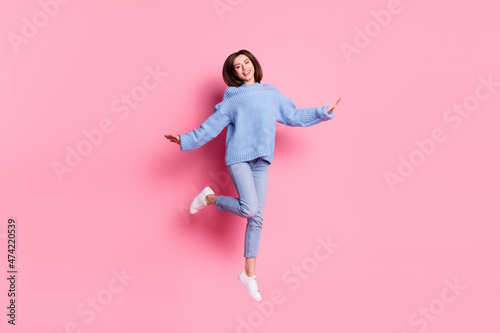 Full length body size view of attractive cheerful sweet brown-haired girl dancing jumping isolated over pink pastel color background