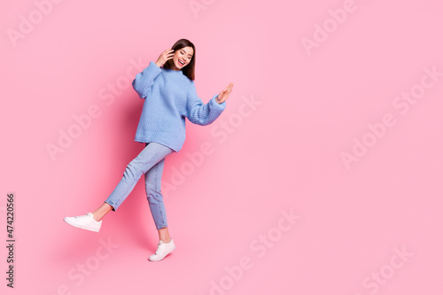 Full length body size view of attractive cheerful brown-haired girl dancing copy space isolated over pink pastel color background