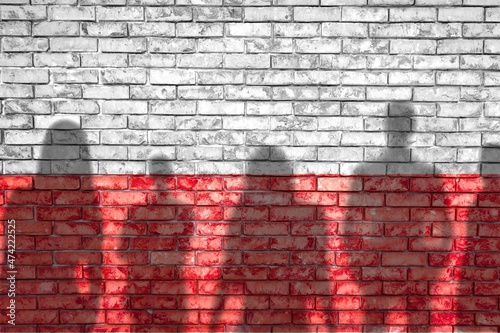 The refugees migrate to Poland. Silhouette of illegal immigrants and flag