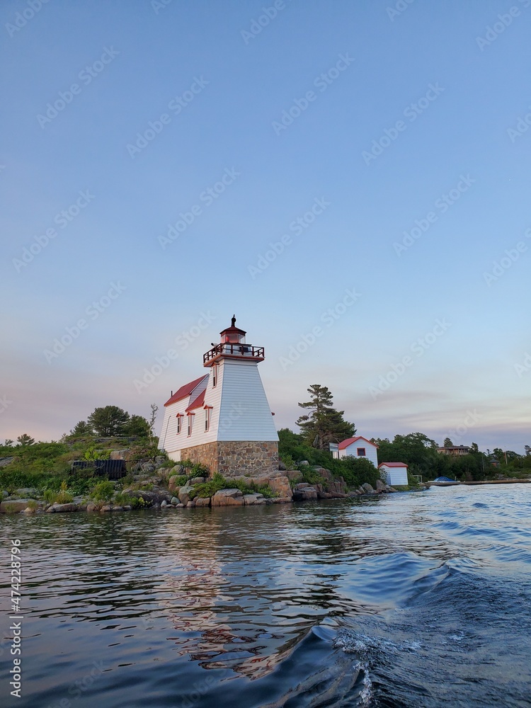 Landscape Lighthouse at Sunset with water