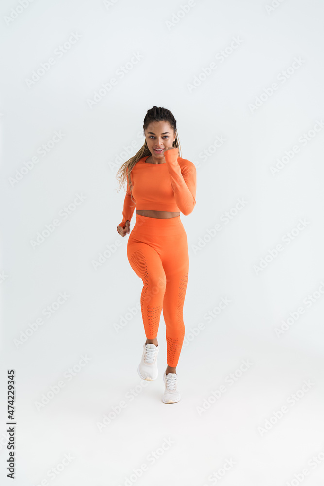 Black young sportswoman running wile working out Black young sportswoman running wile working out