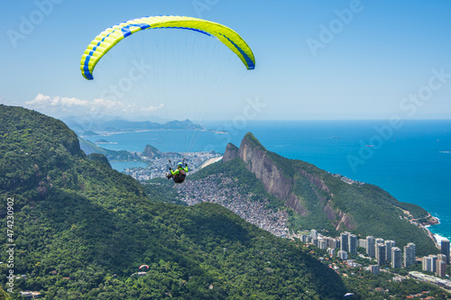 Capture of a guy paragliding at Pedra Bonita and a beautiful landscape - Rio de Janeiro, Brazil