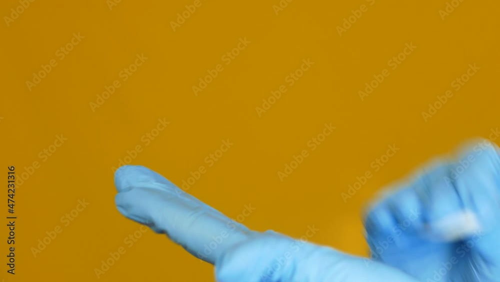 Hygiene and safety in medicine. Close-up of a medic disinfects gloves before work. Doctor with gloves in the laboratory. Clinical study for coronavirus. Selective focus