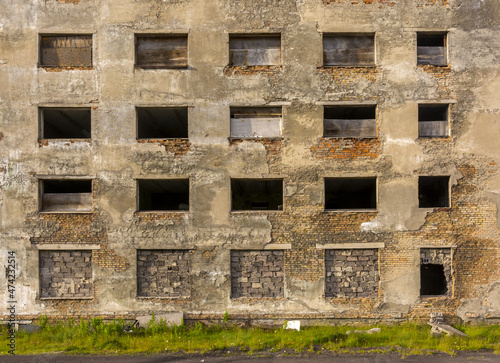 Windows without glass in an abandoned brick house.