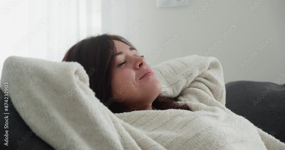 Relaxation practice. Close up woman meditating at home, leaning on couch with closed eyes. Relaxation practice. Close up woman meditating at home, leaning on couch with closed eyes.