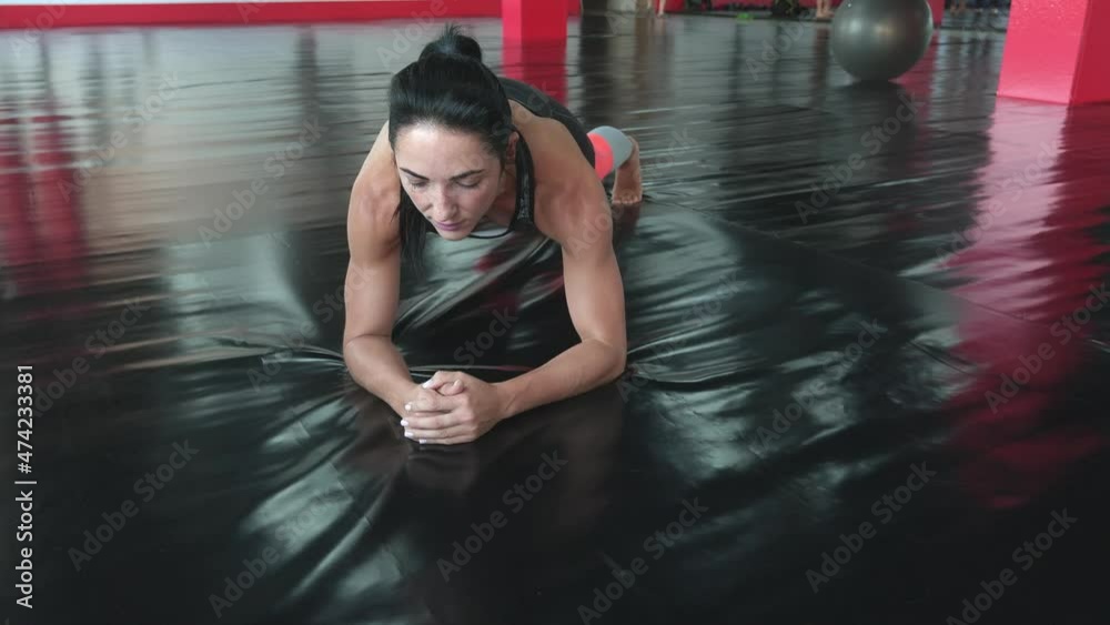 Stretching training. Young woman exercising on fitness mat in gym. Stretching training. Young woman exercising on fitness mat in gym.