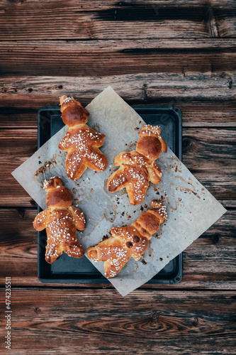 Homemade dough men  - called in German Grittibänzli - made with sweet yeast dough and covered with decorative sugar. Swiss tradition to bake dough men on December 6 and in Advent time. photo