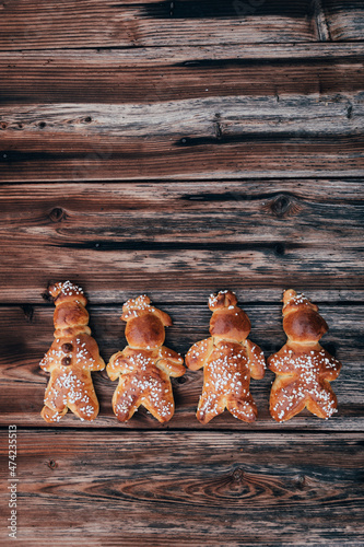 Homemade dough men - called in German Grittibänzli - made with sweet yeast dough and covered with decorative sugar. Swiss tradition to bake dough men on December 6 and in Advent time. photo