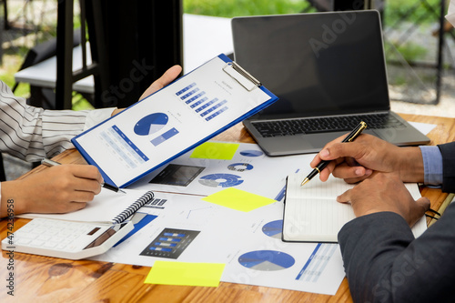 Business people discuss income and performance-based marketing in past meetings, financial advisors analyze data with investors, business ideas working with a team of colleagues and market planners.