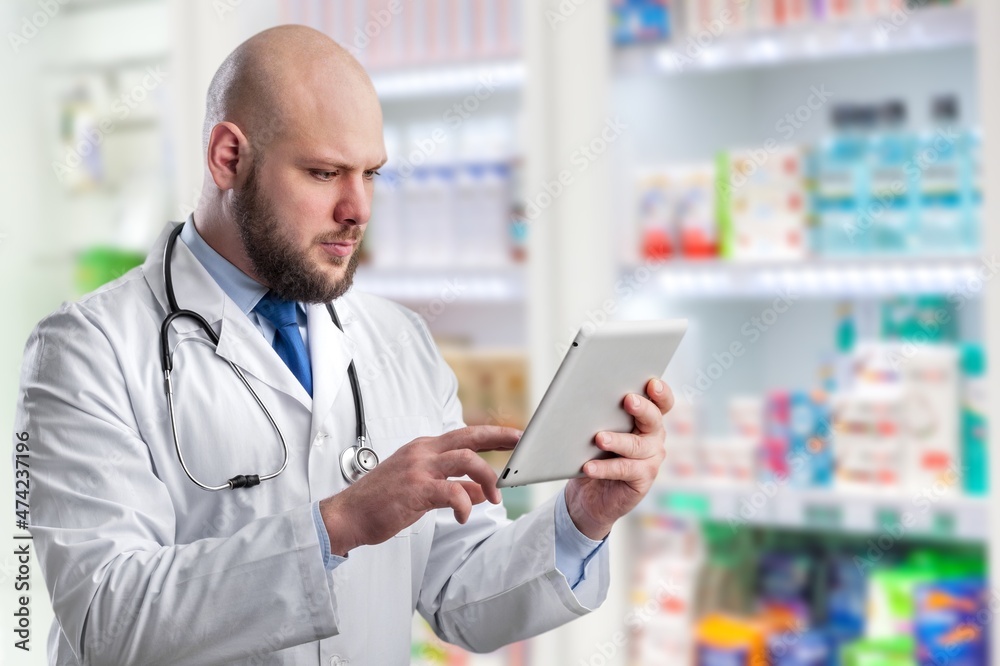 Pharmacy Drugstore: Beautiful Pharmacist Uses Digital Tablet Computer, Checks Inventory Pharmacy Drugstore: Beautiful Pharmacist Uses Digital Tablet Computer, Checks Inventory