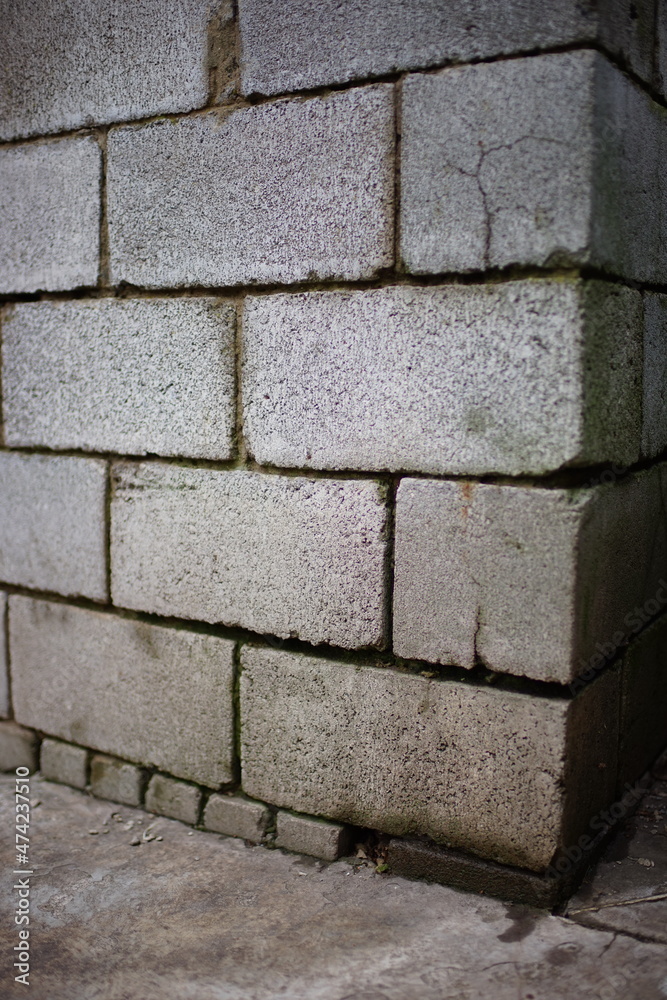 Fototapeta premium Grey cinder block wall with wet seams. Perspective view