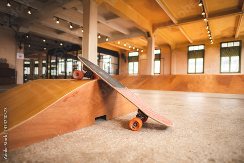 Konstfotografi Skateboard on the mini ramp at skate park indoor with brown wooden floor
