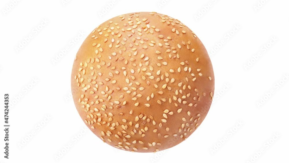 Bun round one with sesame seeds, rotating on white background, top view. Bun round one with sesame seeds, rotating on white background, top view.