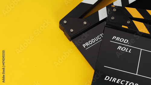 Two Black and yellow Clapper board or movie slate on yellow background.