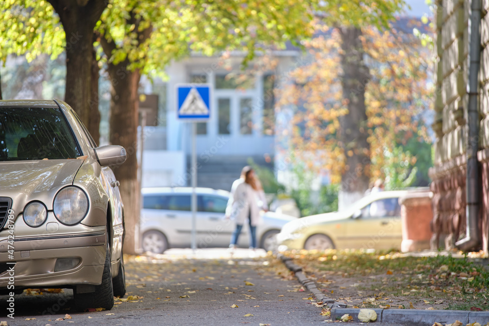 Close up of a car parked illegally against traffic rules on pedestrian city street side Close up of a car parked illegally against traffic rules on pedestrian city street side