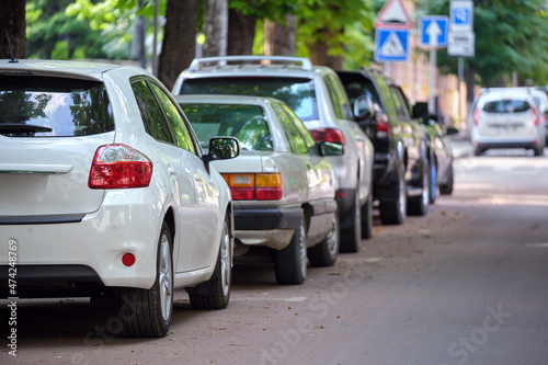 City traffic with cars parked in line on street side © bilanol