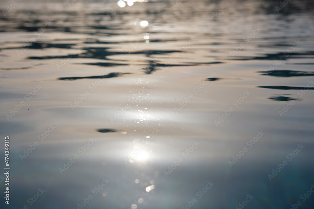 Closeup surface of blue clear water with small ripple waves in swimming pool Closeup surface of blue clear water with small ripple waves in swimming pool