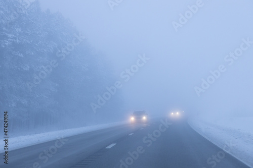 Foggy road in the evening. Winter asphalt road blurred. Blurred photo