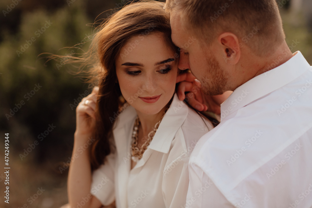 Loving wedding couple outdoor in the rays of the sunset