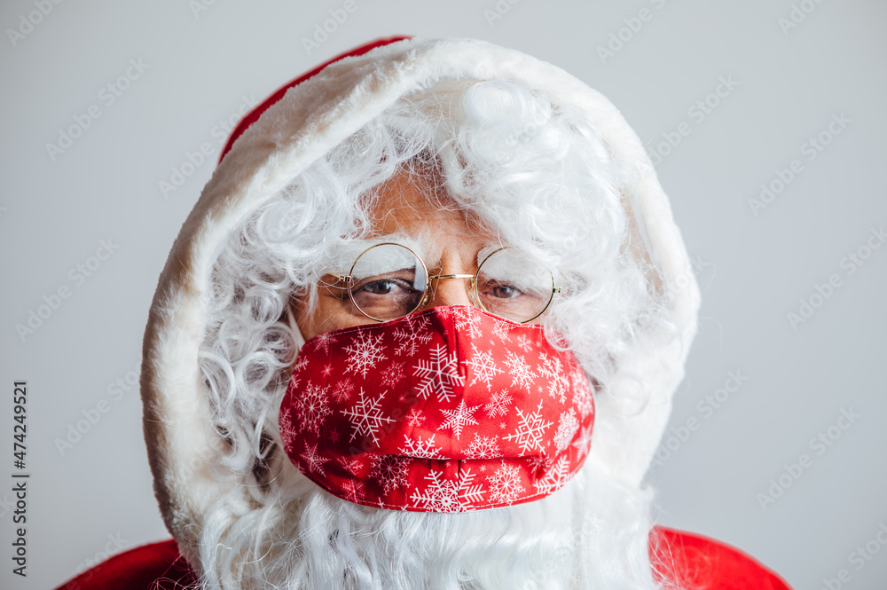 Santa Claus with a red face mask with snowflakes