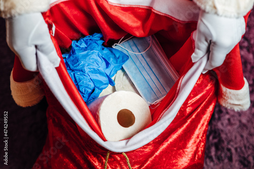 Santa Claus' bag full of toilet paper, face masks and gloves photo