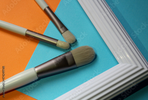 set of makeup brushes on colorful background