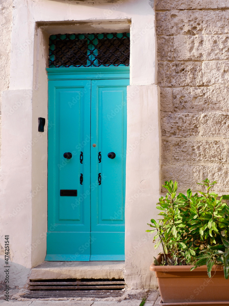 Narrow vintage door of turquoise colour downtown Valetta, Malta