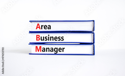 ABM area business manager symbol. Concept words ABM area business manager on books. Beautiful white table, white background, copy space. Business and ABM area business manager concept.
