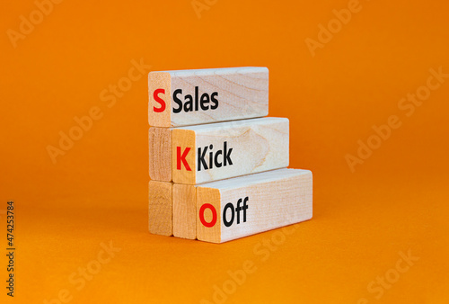 SKO sails kick off symbol. Concept words SKO sails kick off on wooden blocks. Beautiful orange table, orange background, copy space. Business and SKO sails kick off concept.