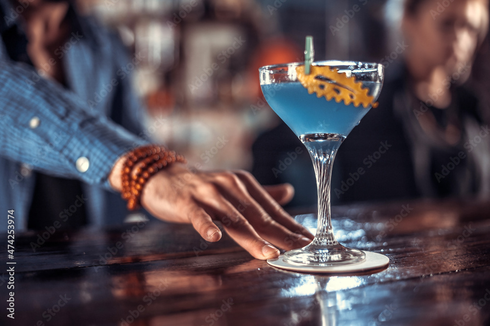 Bartender mixes a cocktail in the saloon