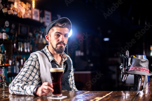 Professional bartender is pouring a drink in the bar