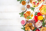 Festive Christmas morning breakfast or brunch table, with traditional foods – pancakes, Belgian waffles, fried eggs, croissant, stolen, cookies, with orange juice and coffee, cinnamon rice porridge 