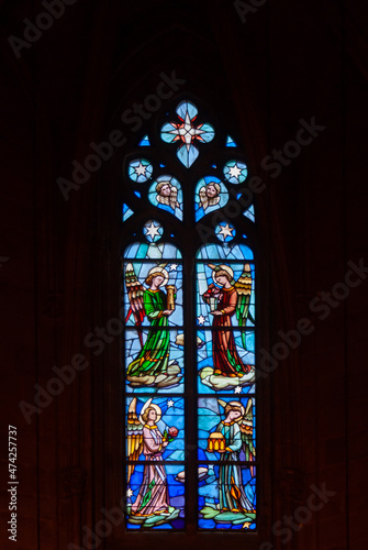 Antique religious stained glass window in an old gothic temple in Spain.