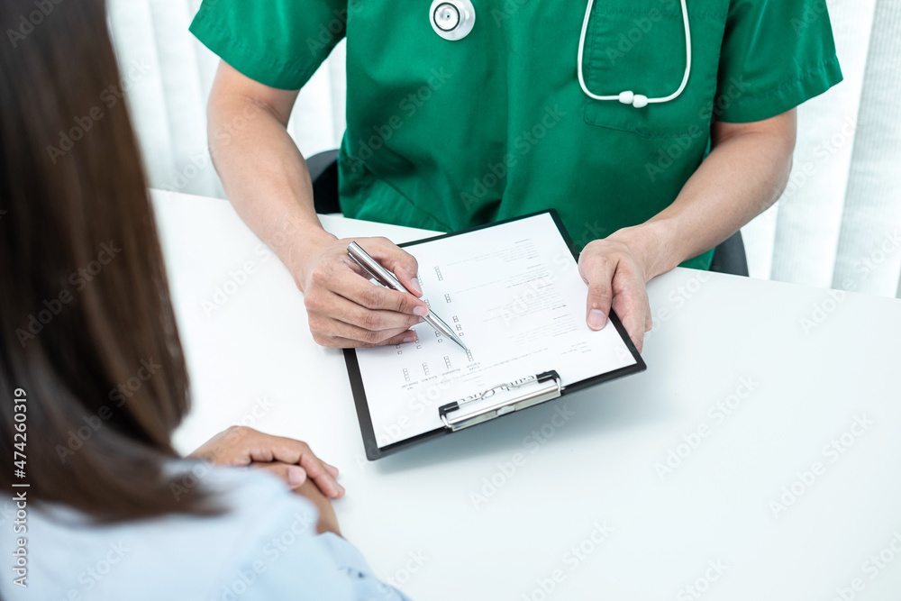 Doctor presenting with the patient and checking results on report and prescription about the problem of illness and recommended treatment method Doctor presenting with the patient and checking results on report and prescription about the problem of illness and recommended treatment method
