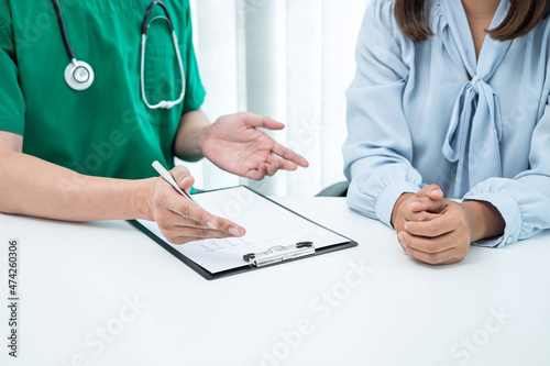 Doctor presenting with the patient and checking results on report and prescription about the problem of illness and recommended treatment method