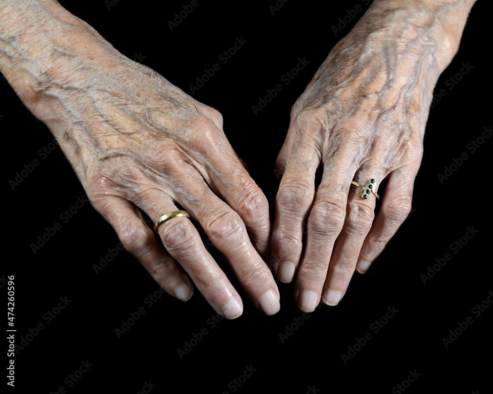 Aging process - very old senior woman hands isolated on black ...