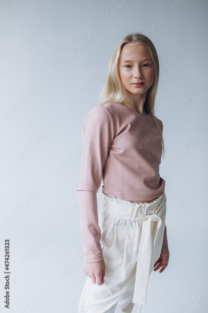 Portrait of blondie young caucasian girl in studio. Fashionable portrait of pretty teen girl Portrait of blondie young caucasian girl in studio. Fashionable portrait of pretty teen girl
