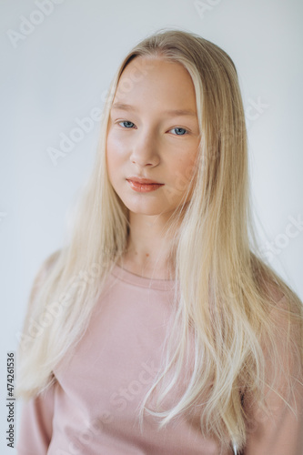 Portrait of blondie young caucasian girl in studio. Fashionable portrait of pretty teen girl