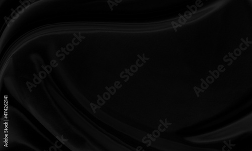 Black gray satin dark fabric texture luxurious shiny that is abstract silk cloth background with patterns soft waves blur beautiful.